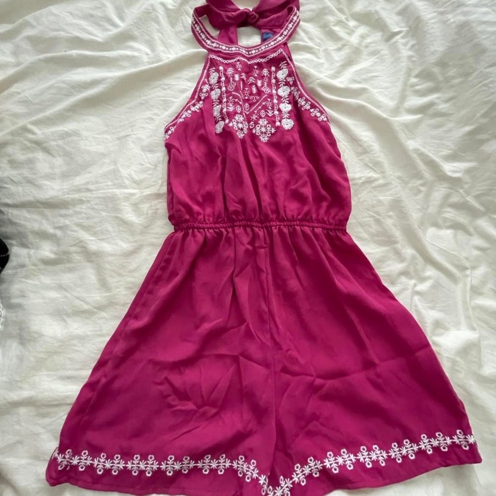 Pink romper with embroidered detail and bow tie back